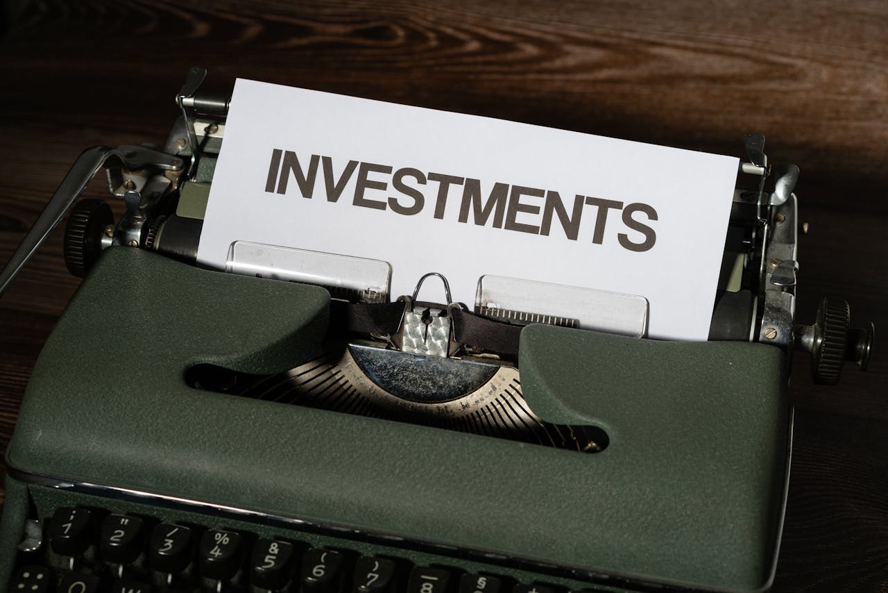 Close-up of a vintage typewriter with a paper labeled INVESTMENTS.
